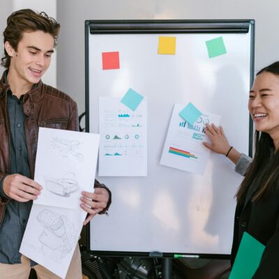 Woman in Black Jacket Holding White Printer Paper